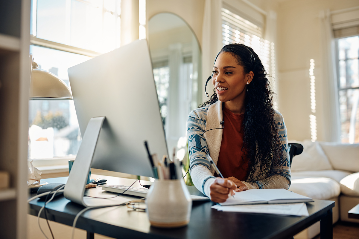 A Benefits Guru taking a call from her home office