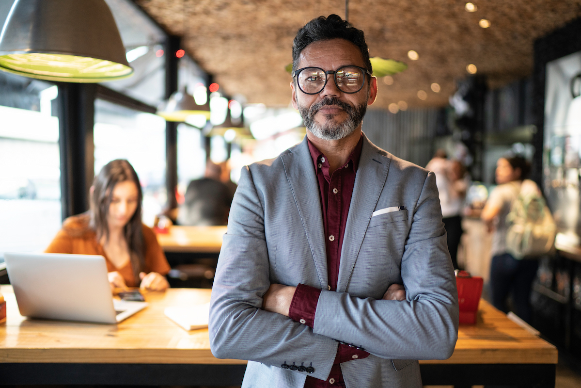 A licensed benefits professional standing in a café