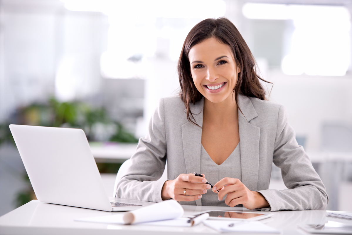 An employee reviewing her benefits options on a laptop at work